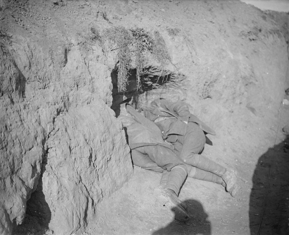 Soldiers sleep near the entrance to their trench. Eaucourt L'Abbaye. November 1916.